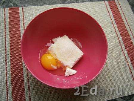 К творогу добавить яйцо, всыпать 1 столовую ложку сахара, соль и 0,5 чайной ложки ванильного сахара.