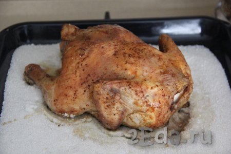Запекать курицу на соли в духовке, разогретой до 220 градусов, в течение 1 часа. Готовность можно проверить, сделав надрез около кости курочки, - если в разрезе выделяется прозрачный сок, значит курица готова, пора доставать из духовки.