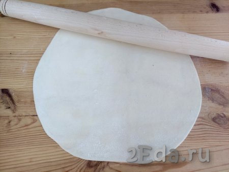 По прошествии времени раскатать тесто на присыпанной мукой поверхности в пласт толщиной около 2 мм.