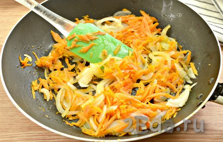 Растительное масло очень хорошо разогреваем на сковороде, выкладываем нарезанный лук и натёртую морковку. Обжариваем овощи, помешивая, на среднем огне 3-4 минуты.