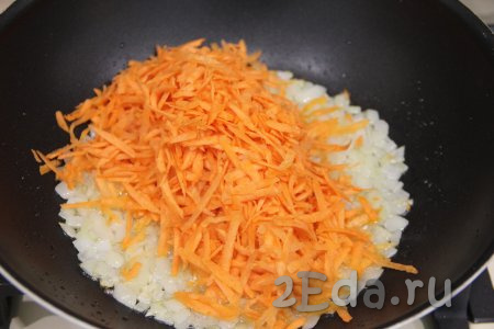 К луку, обжаренному до прозрачности, выложить морковку, перемешать и обжаривать овощи, периодически помешивая, 6-7 минут (до мягкости моркови).