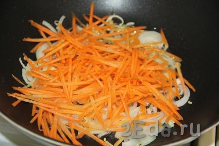 Морковь очистить, натереть на тёрке для моркови по-корейски, добавить в сковороду с луком и обжарить, помешивая, в течение 3 минут.