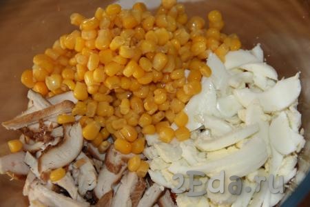 Кукурузу, предварительно слив с неё жидкость, добавить в салат из копчёной курицы, яиц и корейской моркови, перемешать.