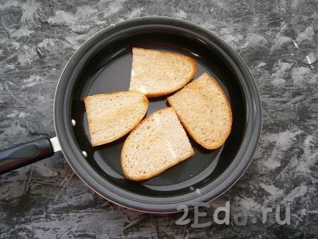 На сковороде разогреть 1 чайную ложку растительного масла, затем выложить кусочки хлеба и подсушить с одной стороны.