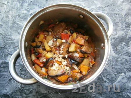 Посолить по вкусу и тушить овощи на небольшом огне около 15 минут, периодически их перемешивая. В конце тушения добавить измельченный чеснок и протушить блюдо еще 3-4 минуты.