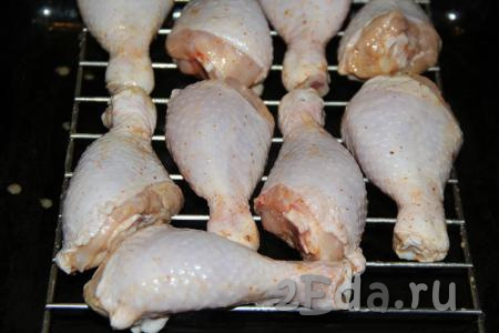 Затем выложить куриные ножки на решётку и поставить в разогретую духовку. Запекать минут 20 при температуре 220 градусов.