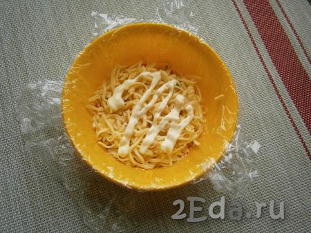 Далее выложить половину сыра с чесноком, нанести майонез.