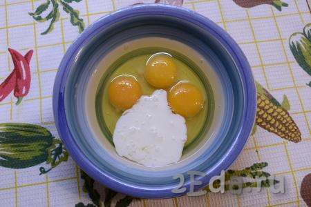 К яйцам добавить кефир (или сметану), всыпать щепотку соли.