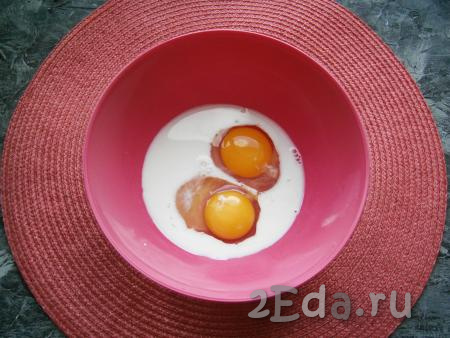Молоко налить в миску, добавить щепотку соли, сахар и разбить 2 яйца.