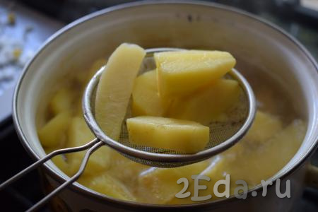 Дольки картофеля, сваренные до полуготовности, достаём из кастрюли при помощи шумовки (или ситечка).