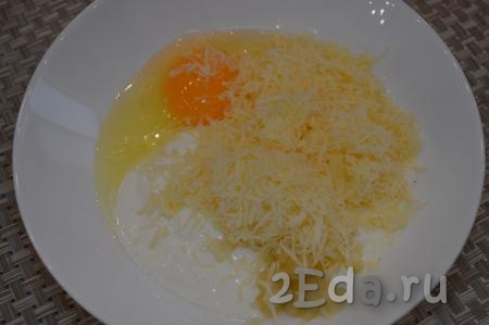 Отдельно натереть твёрдый сыр и добавить его к сметане, чесноку и яйцу. Перемешать сырно-сметанную массу, она должна получиться достаточно густой.