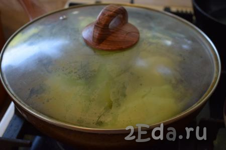 Накрываем сковороду с болгарским перцем крышкой и жарим его со всех сторон, примерно, 12-14 минут, периодически переворачивая перец со стороны на сторону.