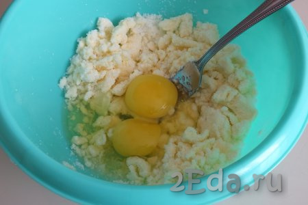 К масляно-сахарной массе добавьте 2 яйца, тщательно перемешайте вилкой.