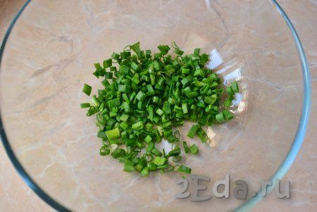 Вымойте, обсушите, мелко нарежьте зелёный лук и выложите в миску.