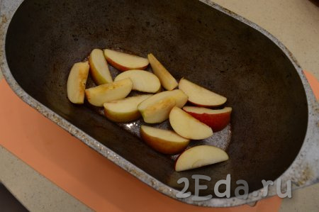 Нарезать яблоки на дольки, часть долек выложить на дно утятницы. Так как утка у нас будет лежать на яблоках, то саму утятницу можно не смазывать никаким жиром.