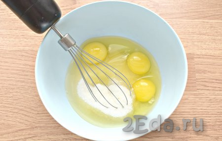 В глубокую миску разбиваем яйца. Всыпаем к ним сахар с солью и взбиваем миксером до пышной пены (в течение двух минут) на средней скорости.