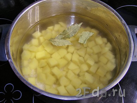Промытый рис и нарезанный картофель кладём в кастрюлю, в которой будем готовить суп, вливаем 2,5 литра холодной воды, добавляем лавровые листья, солим и ставим на сильный огонь. Доводим до кипения, а затем варим рис с картошкой на слабом огне минут 15-20 (и рис, и картошка должны стать достаточно мягкими, но не разваренными).
