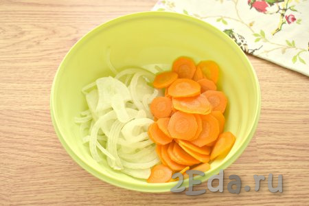 Нарезаем очищенную луковицу полукольцами, перекладываем в объёмную миску, сюда же добавляем очищенную и нарезанную тонкими кружочками морковку.