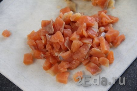 Картофель и морковь вымыть, переложить в кастрюлю, залить овощи полностью водой и отварить в кожуре до готовности (обычно на это требуется минут 25-30, готовые овощи будут легко прокалываться ножом). Свеклу тоже вымыть и отварить в другой кастрюле, не очищая от кожуры, до готовности (на отваривание свеклы обычно требуется 50-60 минут). Варёные морковку, свеклу и картошку достать из воды, полностью остудить, а непосредственно перед приготовлением салата очистить. Яйца сварить вкрутую (на отваривание с момента закипания воды потребуется минут 10), затем охладить их в ледяной воде и очистить. Солёную красную рыбку нарезать на мелкие кубики.