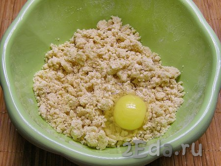 В полученную крошку добавляем яйцо и перемешиваем, замешивая мягкое, не липнущее к рукам тесто.