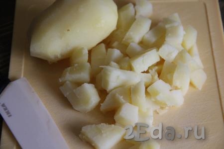 Картофель сварить в кожуре, остудить, очистить и нарезать на кубики среднего размера.