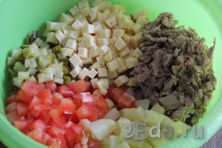 В глубокой миске соединить вареную свинину, картофель, помидор, соленые огурцы и сыр, посолить салат.