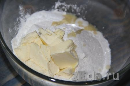 Затем добавить сахар и холодное сливочное масло, нарезанное ножом на кусочки или натертое на крупной терке.