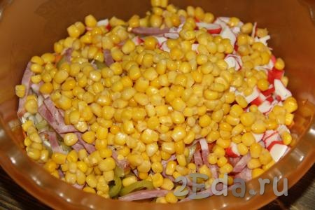 С кукурузы слить жидкость. Крабовые палочки и кукурузу добавить в салат, посолить по вкусу.