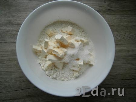 В муку добавить холодное, нарезанное кусочками сливочное масло (или маргарин), всыпать 1 столовую ложку сахара.