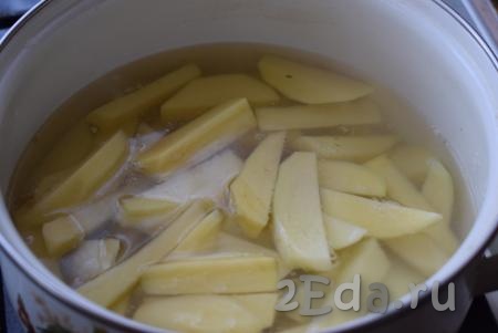 В кастрюле вскипятим воду, подсолим её. В закипевшую воду выкладываем дольки картофеля и варим с момента закипания, примерно, 5-7 минут.